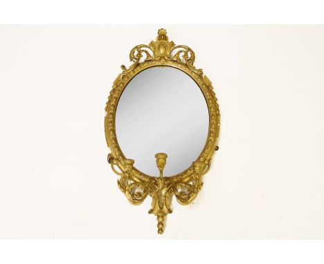 A 19th century gilt wood and composition wall mirror,the oval plate surmounted by carved cresting fitted triple acanthus leaf