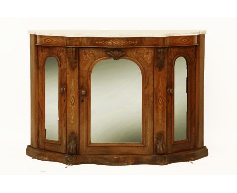 A Victorian walnut credenza the marble top over serpentine front, with mirror panelled doors, on a plinth base, 120 x 84 x 35