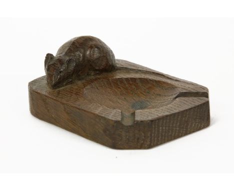 A carved oak ashtray by Robert 'Mouseman' Thompson, surmounted by a carved mouse, 10cm long