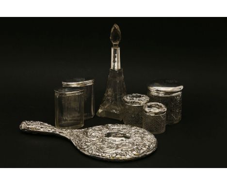 A collection of five silver topped dressing jars, a silver mirror, and a glass and silver Art Deco perfume bottle