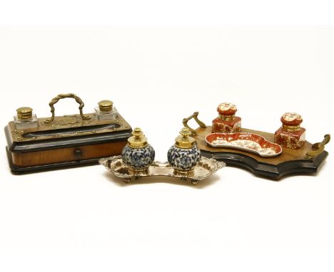 An inkwell and stand with mahogany frame and cast iron motif,a side drawer together with another similar with red robin ceram