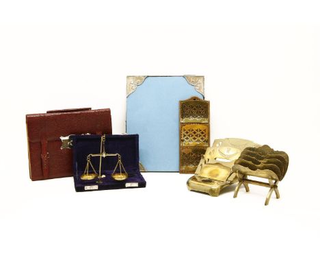 A set of brass scales, boxed,  a quantity of brass letter holders and a leather travelling writing compendium, modelled as a 