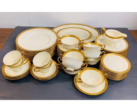 A Royal Doulton bone china part dinner service with gilt rim edge to include, serving dishes, eleven dinner plates, seven two