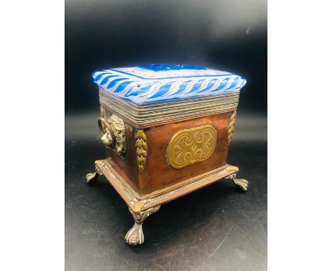 A Copper and Glass Lidded caddy on ball and claw feet with lion loop handles.