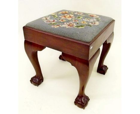 An early 19th century mahogany stool with tapestry seat and claw feet