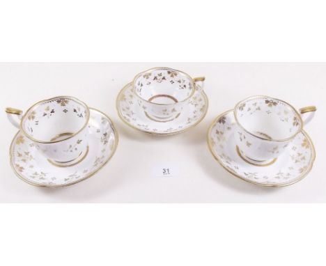 A Victorian gilt and white set of four tea cups and saucers and four coffee cups and saucers