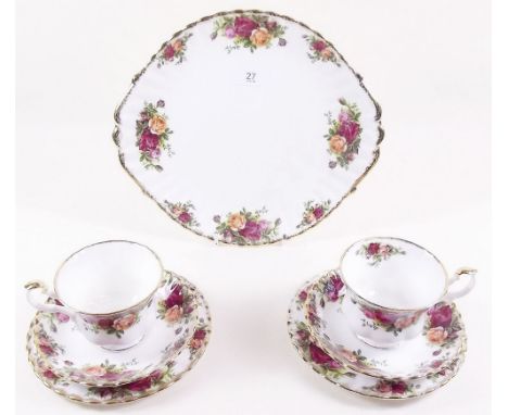 A Royal Albert Country Roses tea service comprising six cups and saucers, six tea plates, cake plate, milk and sugar