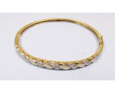 A 9 carat gold hinged bangle