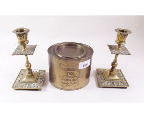 A pair of brass candlestick and a brass tea caddy
