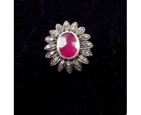 A ruby and diamond flower form ring