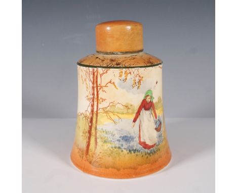 A Royal Doulton hand-painted ceramic tea caddy featuring a scenic countryside landscape. The design showcases a woman in trad