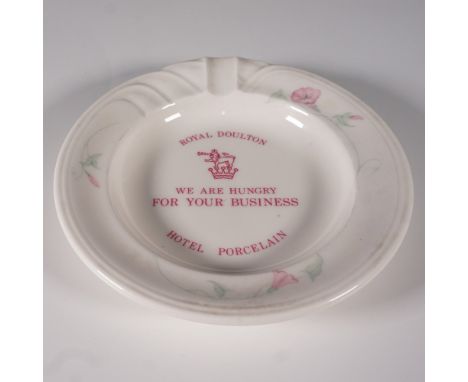 A vintage Royal Doulton hotel porcelain ashtray featuring a floral rim design and a humorous red printed message, "We Are Hun