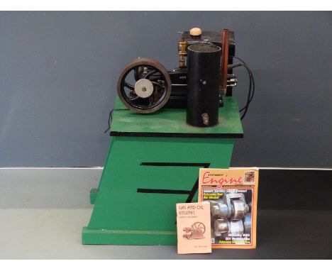 Stuart Turner model 400 stationary gas or petrol engine with open crank and spoked flywheel on wooden plinth, with related ma