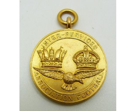 A 9ct gold Inter-service Association Football medal with eagle below two crowns, engraved Winners 1929-1930 Royal Navy and Ro