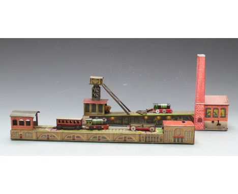 Two Arnold clockwork tinplate railways, one in the form of a coal mine with engine shed, the other in the form of a train sta