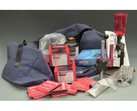 A collection of cartridge loading accessories including a Lee Perfect Powder Measure, Hornady .38 .358 bullets, Fiocchi shots