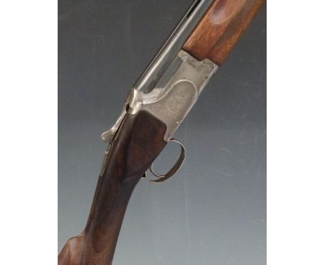 Winchester 12 bore over and under shotgun with engraved scenes of birds to the locks, engraved underside, trigger guard, top 