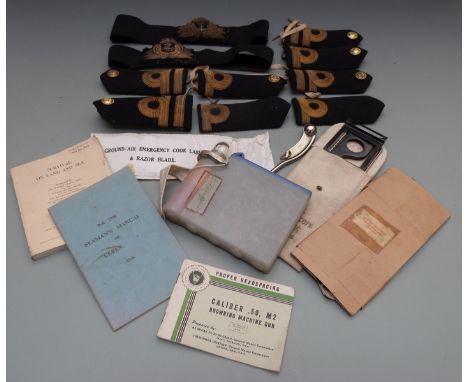 A quantity of Royal Navy cloth badges and insignia including cap badges and epaulettes, together with a bosun's whistle, pilo