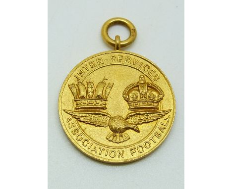 A 9ct gold Inter-service Association Football medal with eagle below two crowns, engraved verso 1926-27 Tel R Dixon, 10.9g