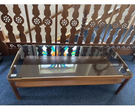 Teak Coffee Table, smoked glass top and shelf, stylish design throughout.  Measures 44'' wide, 14'' high, along with a leathe