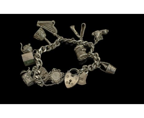 A Good Quality Vintage Sterling Silver Curb Bracelet, Loaded with 11 Silver Charms. All Marked for Sterling Silver. Comprises