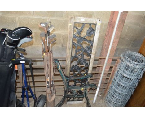 A wood and metal bench back and two bench ends