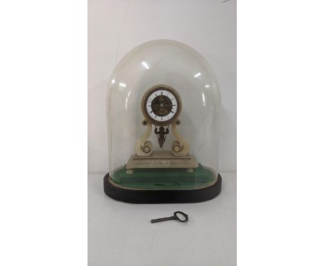A late 19th century French alabaster mantle clock having pendulum fashioned as a swing cherub A/F standing with a glass domeL