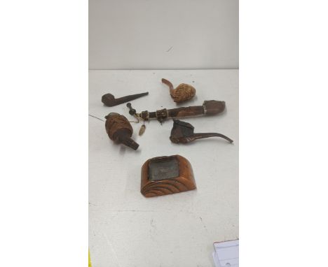 A group of smoking pipes to include a 19th century Meerschaum carved pipe fashioned as a bearded gentleman with an amber mout