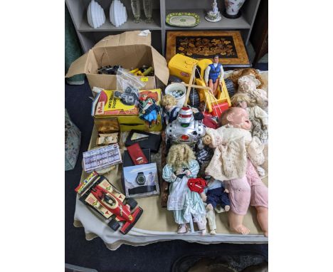A large collection of games to include Action Man, a Little Tikes ride on tractor, dolls, dominoes, a Pelham Puppet and other