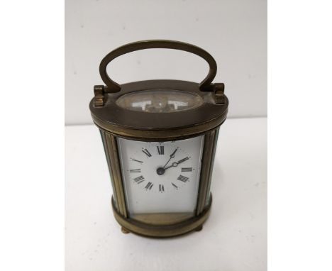 A 20th century brass cased oval carriage clock, with keyLocation: 4.1If there is no condition report shown, please request