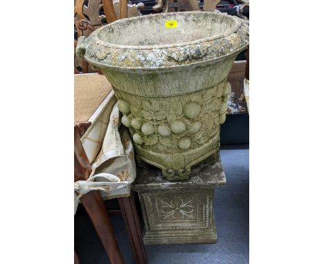 A Willowstone weathered garden concrete planter with twin cast scroll handles, raised relief fruit and leaf decoration to the