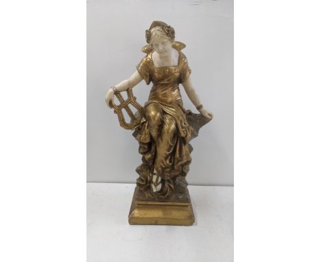 A resin sculpture of a woman seated on rocks holding a harp, 58cm highLocation:If there is no condition report shown, please 