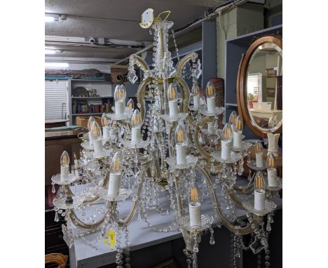 A large pressed and cut glass 12-branch chandelier with faceted glass drops and swags, and a similar smaller twelve-branch ch