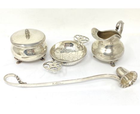 A GROUP OF FOUR 20TH CENTURY ITEMS comprising: a tea strainer, simply pierced, with openwork flat handles, 'TIFFANY &amp; CO 