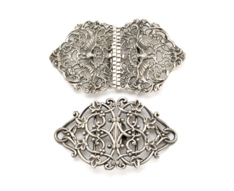 A COLLECTION OF FIVE BUCKLES AND TWO SASH PINS comprising: a Victorian silver buckle, of openwork scrolling berried tendrils,