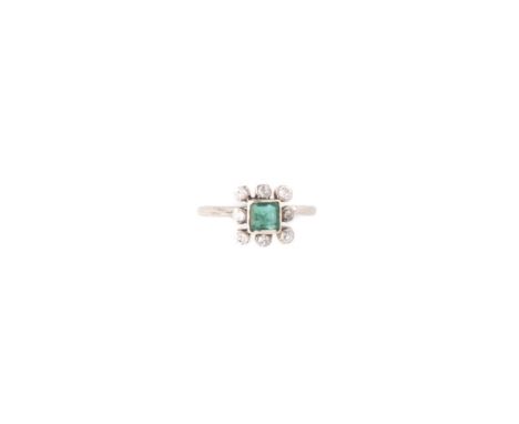 EMERALD AND DIAMOND RING designed as a cluster, set to the centre with a square emerald within a border of circular diamonds 