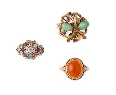 A COLLECTION OF DRESS RINGS comprising: jade and ruby textured cluster ring, 1960s; polished oval carnelian ring; domed ring 