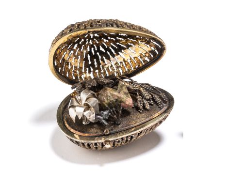 A SILVER-GILT SURPRISE EGG, STUART DEVLIN, LONDON, 1977 the openwork 'filigree' body hinging via a pushpiece to reveal a rhod