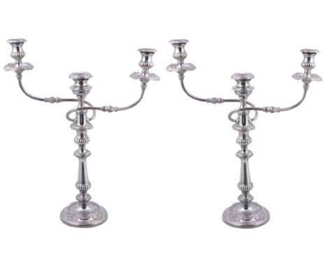 A PAIR OF GEORGE III SILVER AND SHEFFIELD PLATE CANDELABRA, S.C. YOUNGE &amp; CO., SHEFFIELD, 1815 with lobed bands and reede