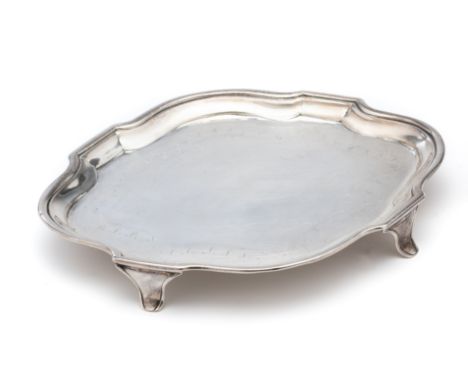 A GEORGE III SILVER TEAPOT STAND, HENRY CHAWNER, LONDON, 1791 shaped oval, with a bright-cut foliate and wigglework border be