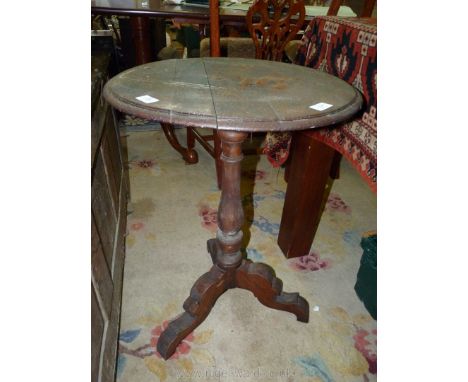 A circular mixed woods occasional Table standing on a turned pillar and with three fretworked splay feet, 19 3/4'' diameter x