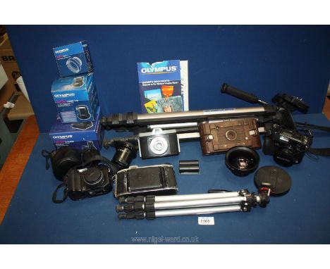 An Olympus C-7070 wide zoom 7.1 mega pixel digital Camera with spare battery, power battery holder, conversion lens adaptor, 