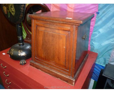 A Mahogany finished storage Box of tapering square form having a raised and fielded panel to the front and brass carrying han