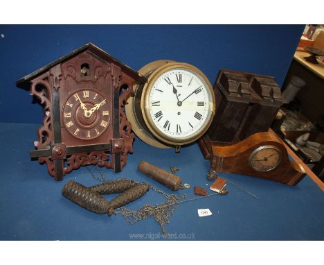 A Cuckoo clock with weights, two other clocks and a clock shelf