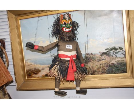 An ethnic/carved mask puppet having grass skirt, 18" tall.