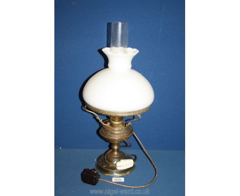 A Brass oil lamp with chimney and white shade, converted to electric