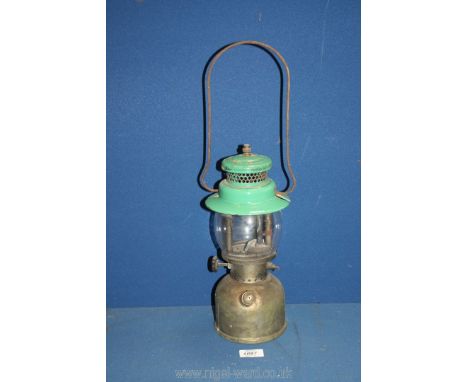 A brass 'Coleman' paraffin lamp having green enamel top, 13'' tall.