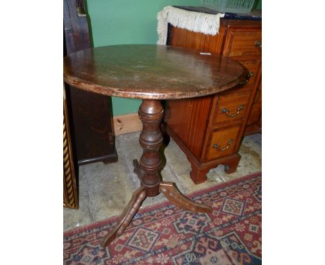 A circular Oak occasional Table standing on turned pillar with three splay feet, 22'' diameter x 27'' high.