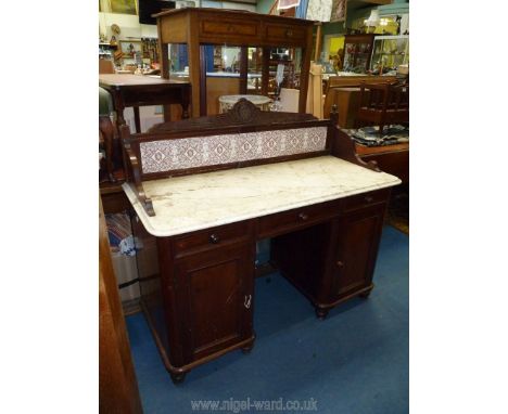 A Victorian Mahogany white marble topped kneehole Washstand having a tiled up-stand, three frieze drawers and a pair of oppos