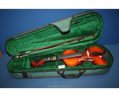 A soft cased Antoni 1/2 debut violin, model no: Acv32 with bow and an unopened Stagg violin hanger. 